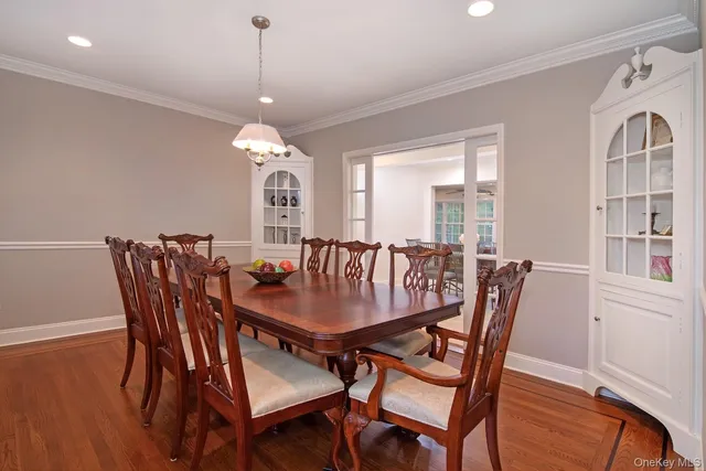 a dining room with furniture window and wooden floor