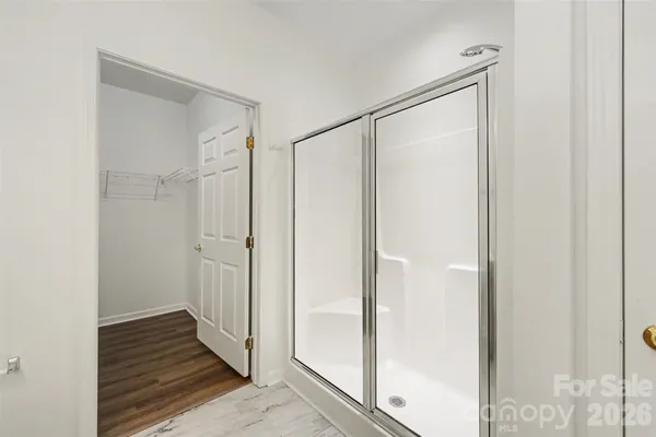 a bathroom with a shower and a glass door