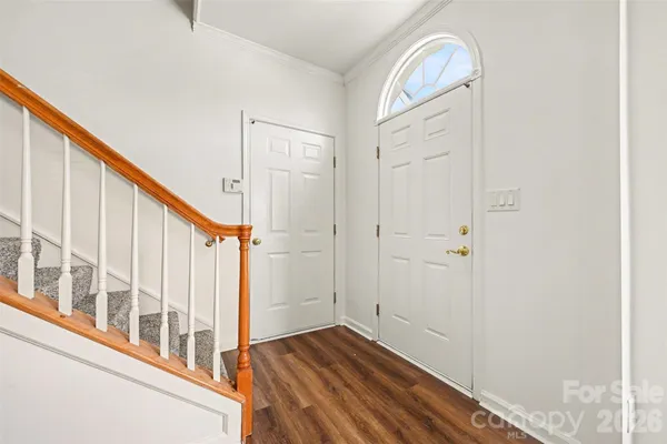 a view of an entryway with wooden floor