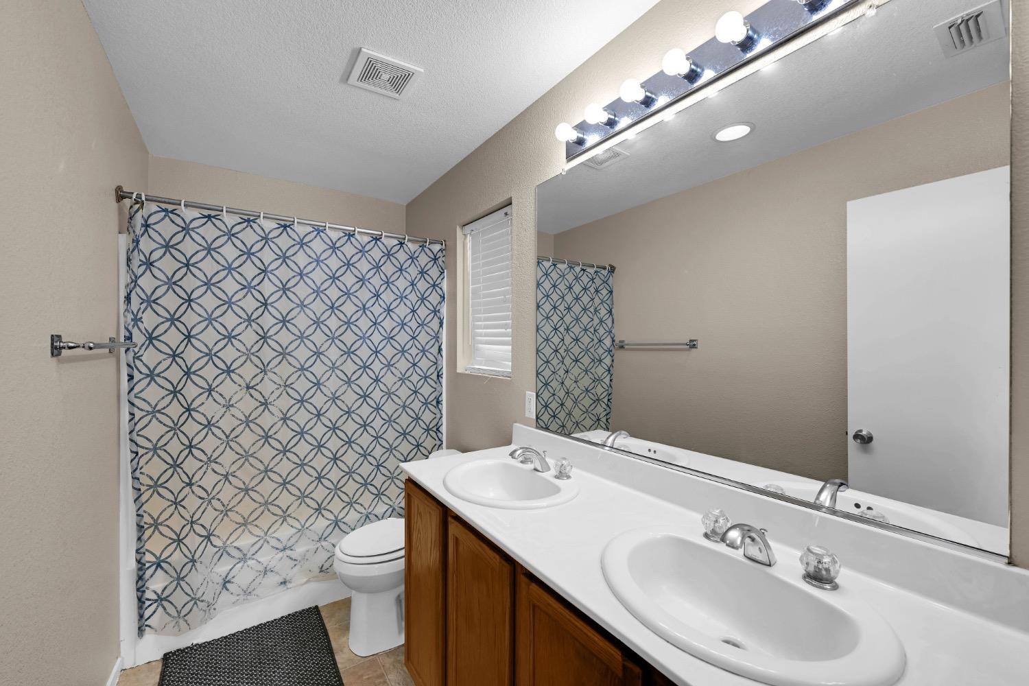 4627 Excelsior Road Mather, CA 95655 - Photo 16 of 33 a bathroom with a sink toilet and a mirror