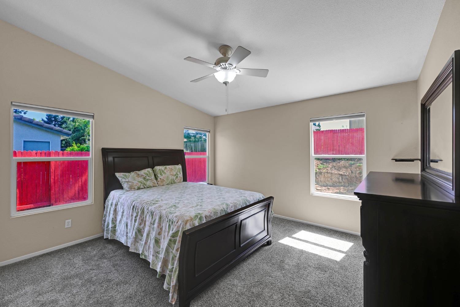 4627 Excelsior Road Mather, CA 95655 - Photo 17 of 33 a bedroom with a bed and a dresser next to a window