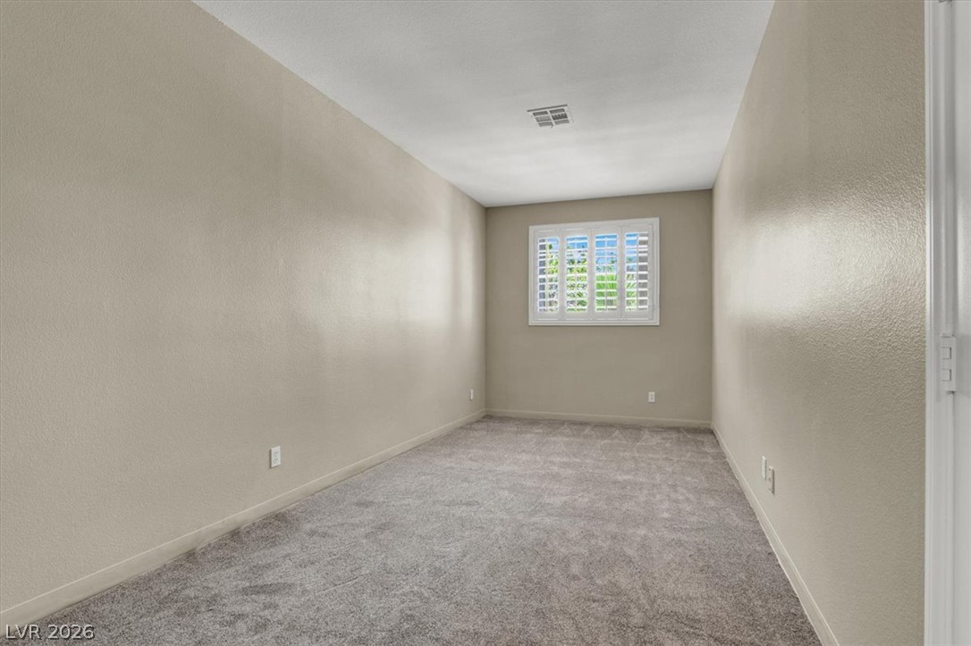 7308 Rustic Meadow Street Las Vegas, NV 89131 - Photo 23 of 27 An inviting room, ready for personal touches, featuring a window with plantation shutters.