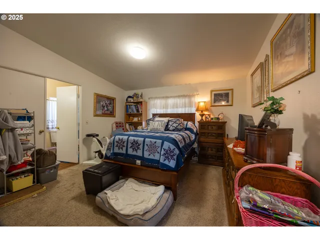 a bedroom with furniture and a flat screen tv