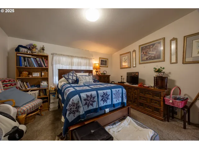 a bedroom with a bed window and a couch