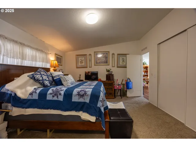 a bed room with bed and a night stand