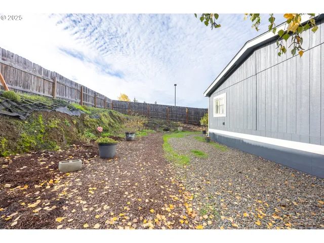 a view of a house with a yard and garage