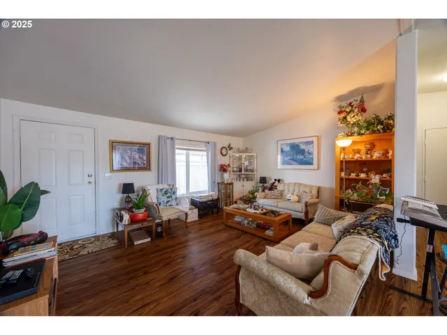 a living room with furniture a wooden floor and a window