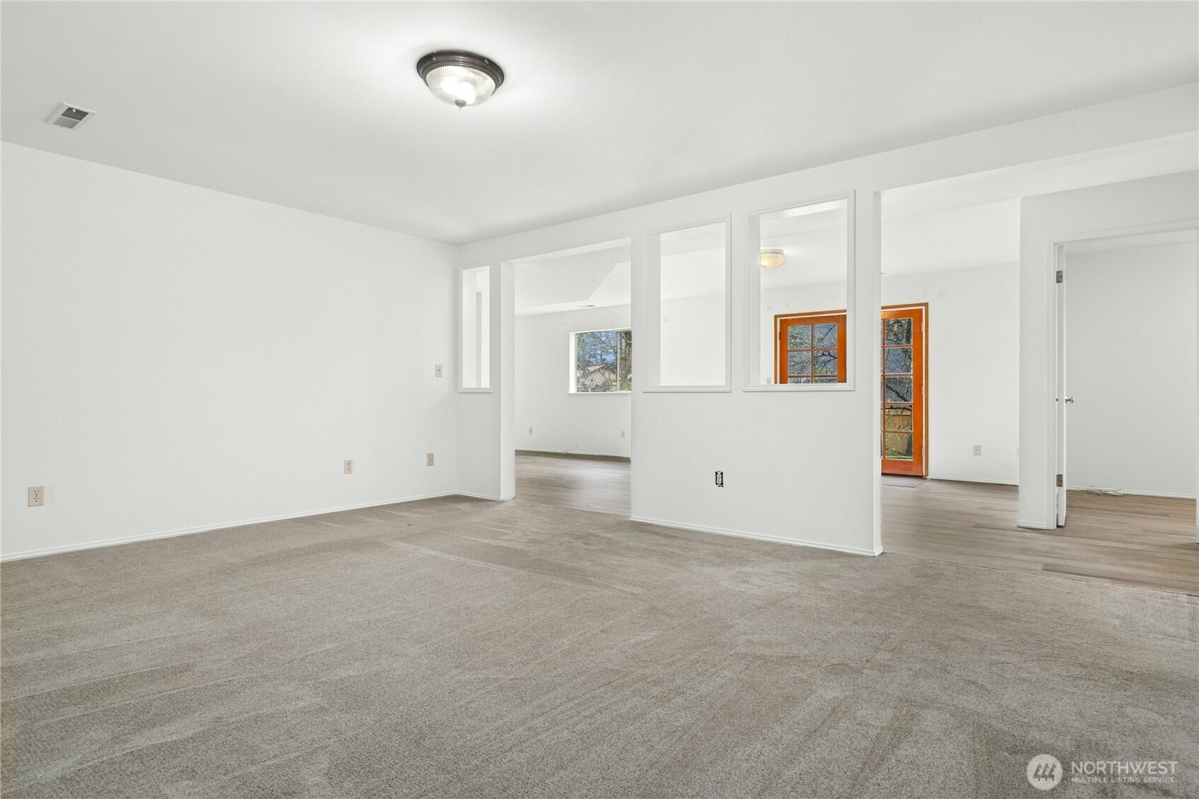 26603 199th Place Southeast Covington, WA 98042 - Photo 12 of 36 an empty room with windows and entrance to other room