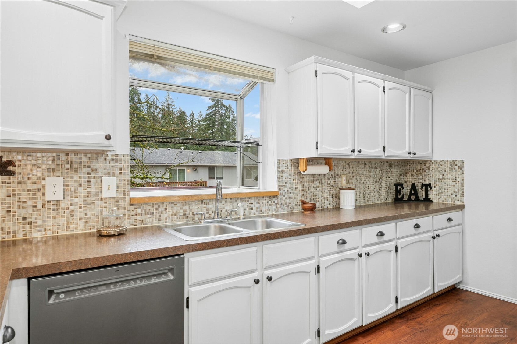 26603 199th Place Southeast Covington, WA 98042 - Photo 7 of 36 a kitchen with stainless steel appliances granite countertop white cabinets sink and window