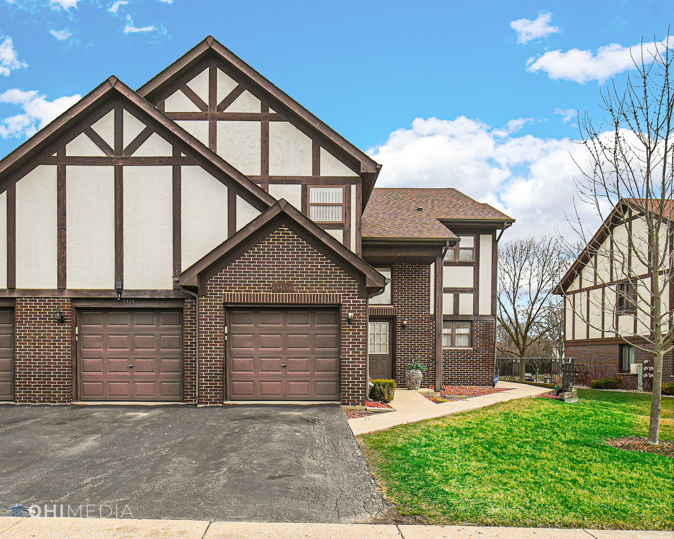 3415 Huntley Terrace, Unit D Crete, IL 60417 - Photo 3 of 22 a front view of a house with a yard and garage