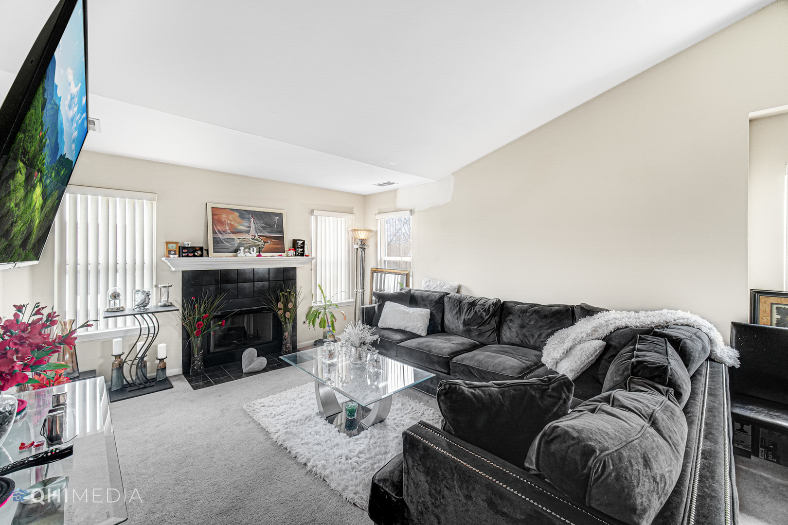 3415 Huntley Terrace, Unit D Crete, IL 60417 - Photo 7 of 22 a living room with furniture a fireplace and a flat screen tv