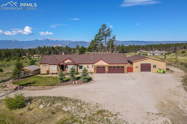 12810 Holmes Road Colorado Springs, CO 80908 - Photo 43 of 45 Ranch-style house with a garage and a mountain view
