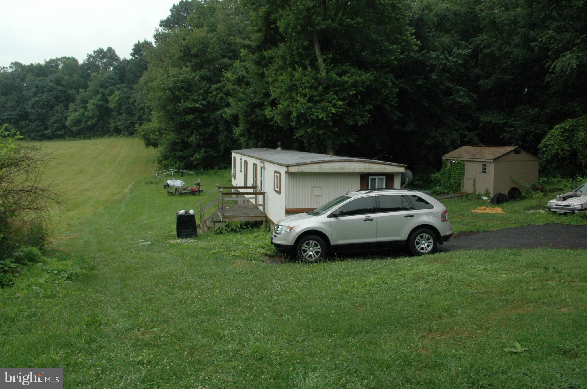 3923 Street Road Street, MD 21154 - Photo 6 of 7 a view of yard with house and car parked