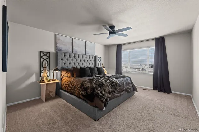 a bed sitting in a bedroom next to a window