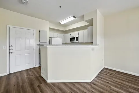 a kitchen with a sink and a wooden floor