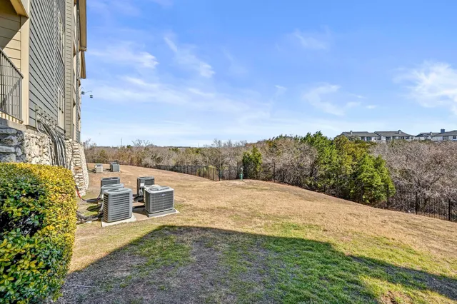 a pathway of building with yard in back