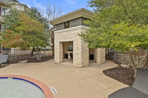 a kitchen with granite countertop a refrigerator stove and sink