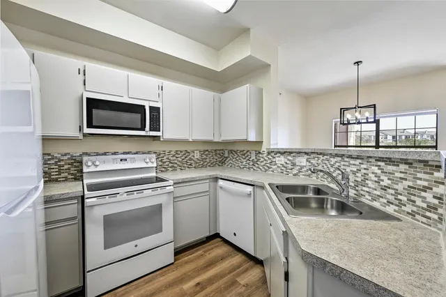 a kitchen with a sink stove and microwave