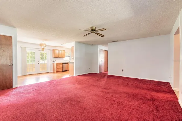 a view of a room with wooden floor and a window