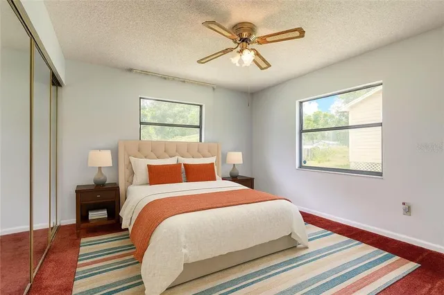 a view of empty room with window and ceiling fan