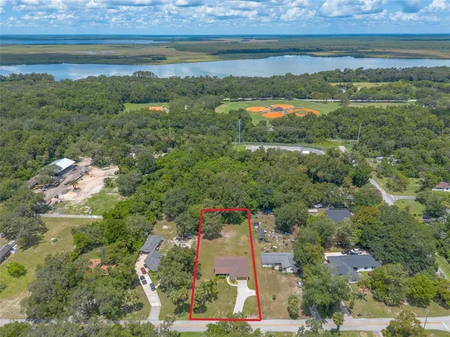 a view of a kitchen with wooden floor and electronic appliances