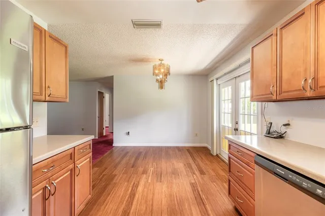a view of kitchen with granite countertop window and sink