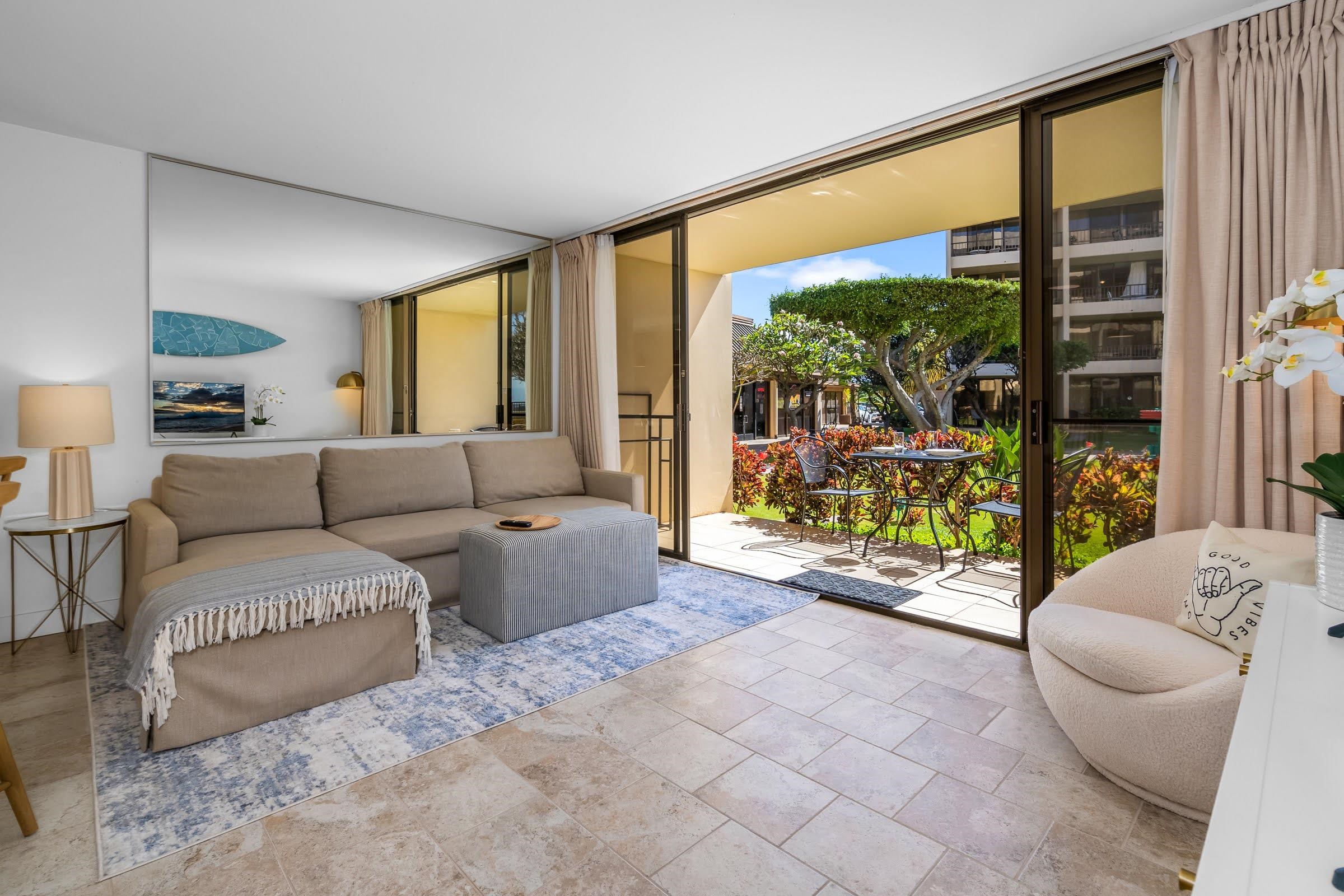 145 North Kihei Road, Unit 103 Kihei, HI 96753 - Photo 11 of 49 a living room with furniture and a large window