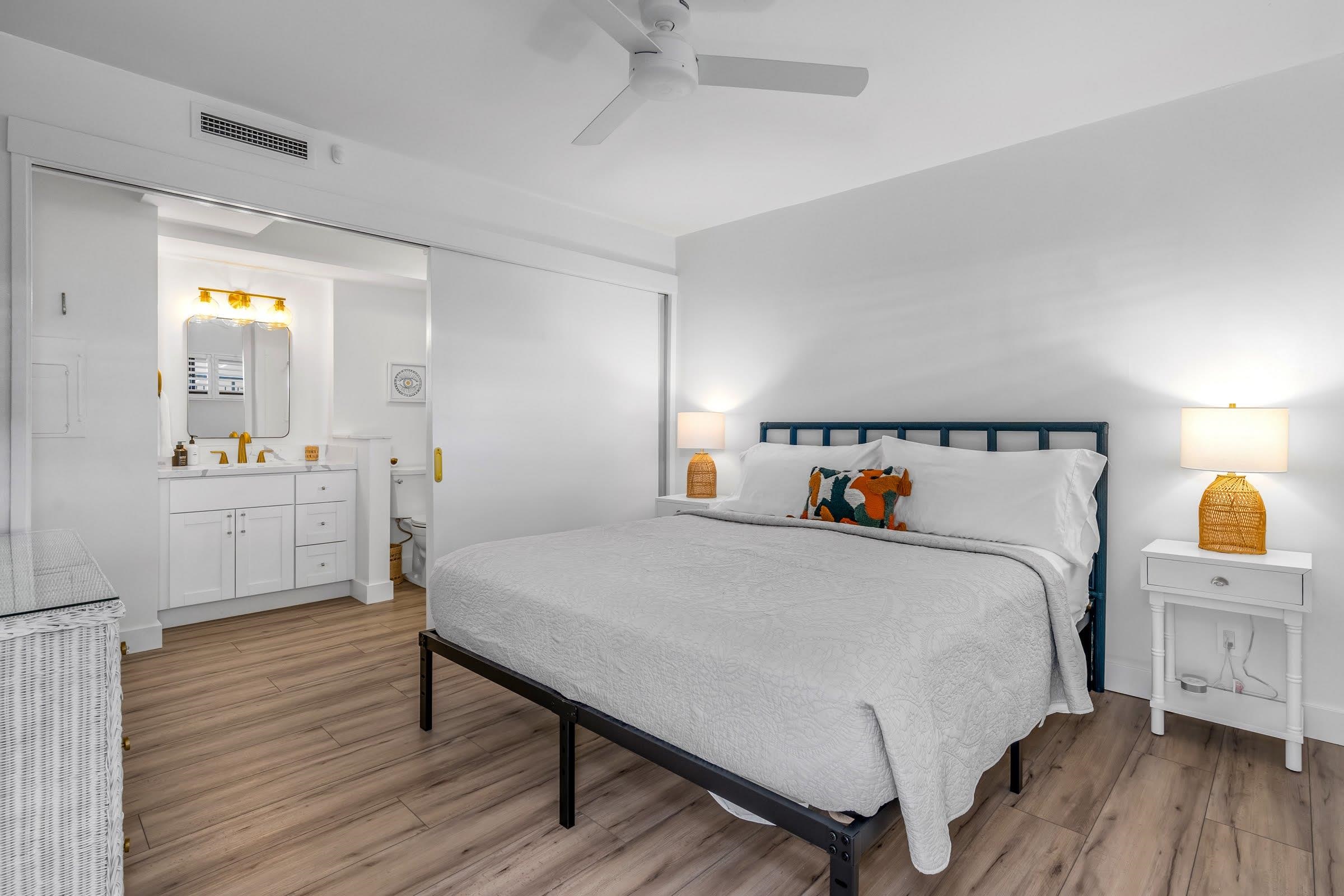 145 North Kihei Road, Unit 103 Kihei, HI 96753 - Photo 17 of 49 a bedroom with a bed and wooden floor