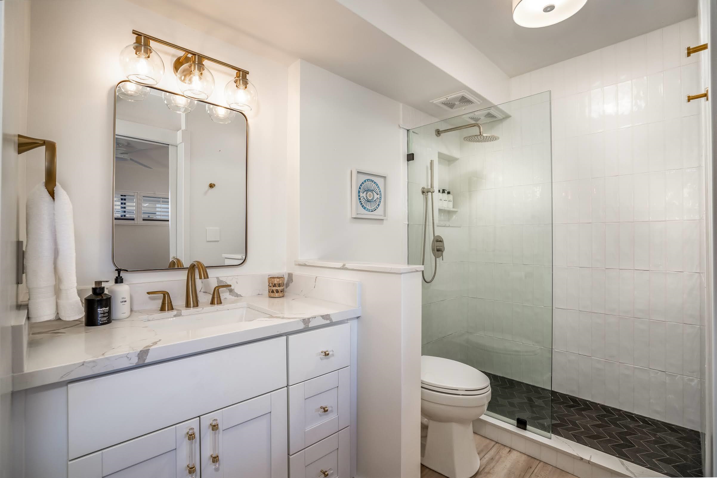 145 North Kihei Road, Unit 103 Kihei, HI 96753 - Photo 22 of 49 a bathroom with a sink a toilet a shower and a mirror