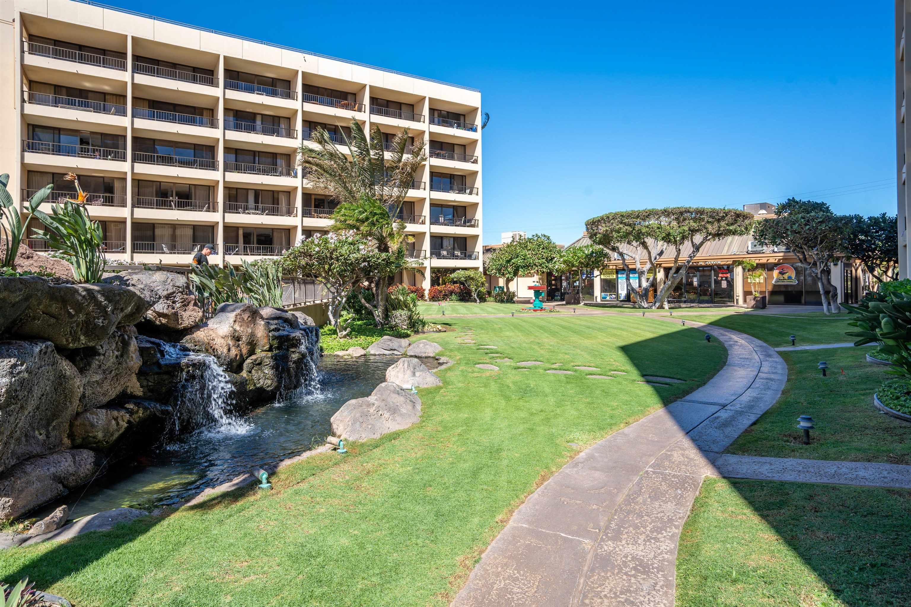 145 North Kihei Road, Unit 103 Kihei, HI 96753 - Photo 32 of 49 a view of a building with garden and sitting area