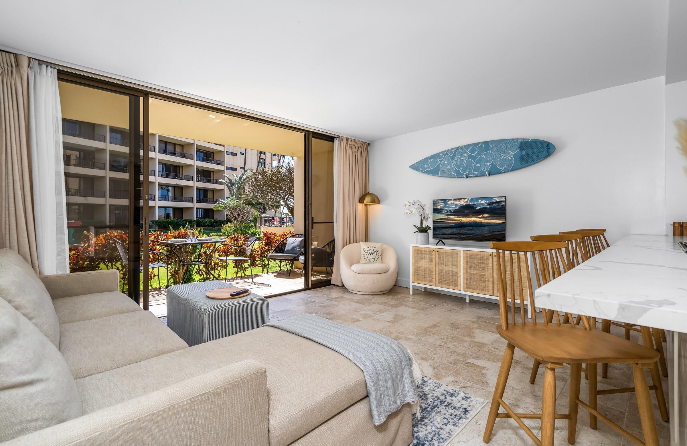 145 North Kihei Road, Unit 103 Kihei, HI 96753 - Photo 10 of 49 a living room with furniture and a large window