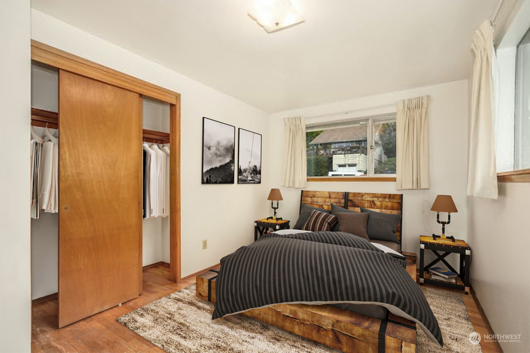 4151 23rd Avenue Southwest Seattle, WA 98106 - Photo 17 of 36 a bedroom with a bed and wooden floor
