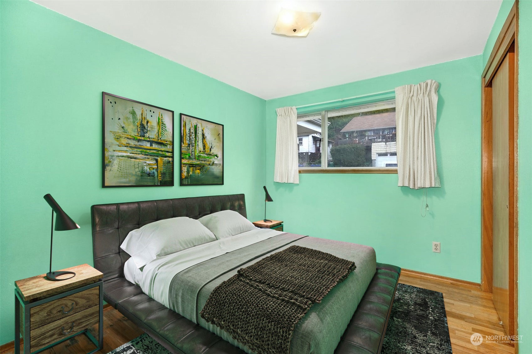 4151 23rd Avenue Southwest Seattle, WA 98106 - Photo 18 of 36 a bedroom with a bed and wooden floor