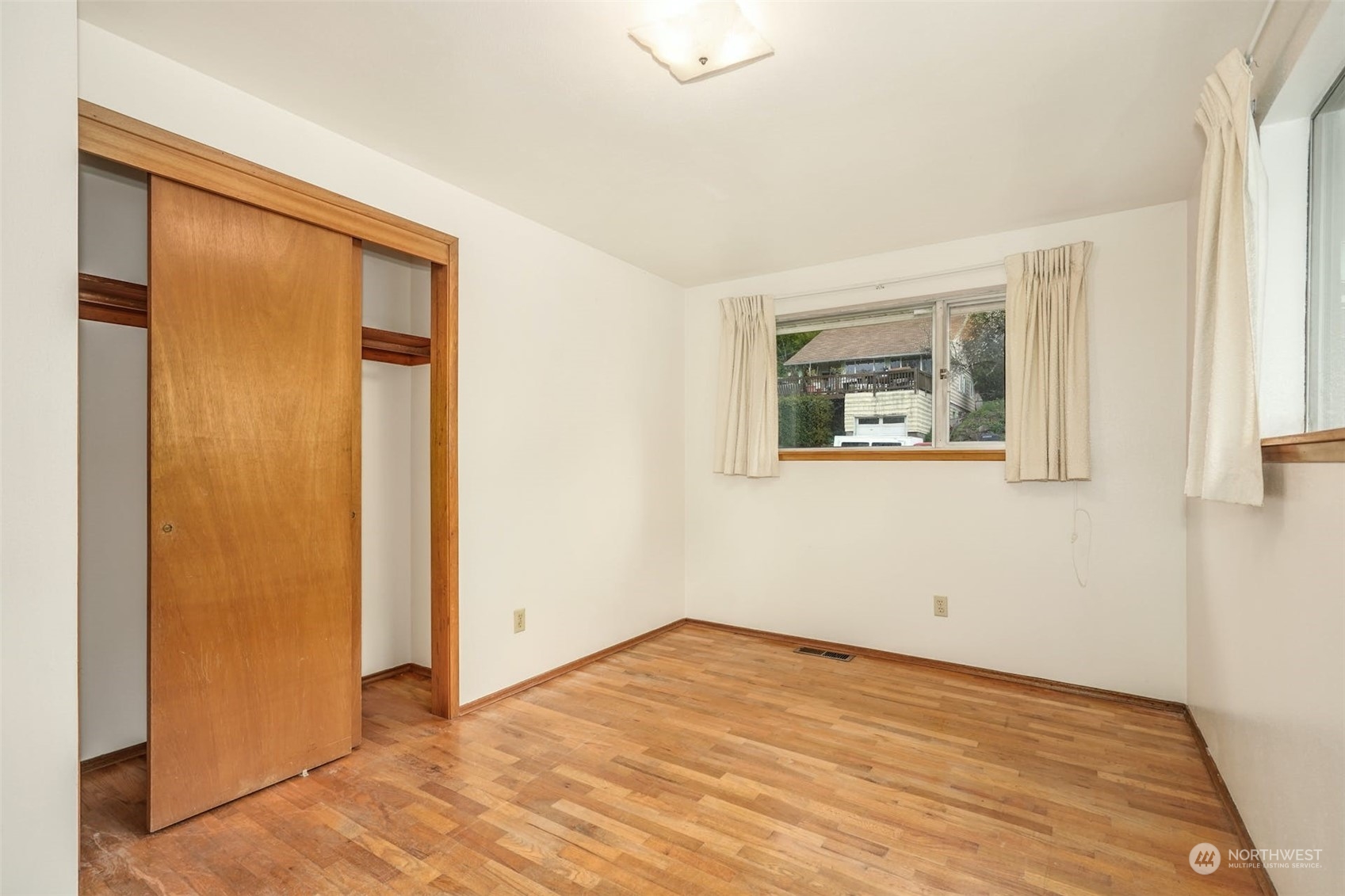 4151 23rd Avenue Southwest Seattle, WA 98106 - Photo 20 of 36 a view of an empty room with wooden floor and a window