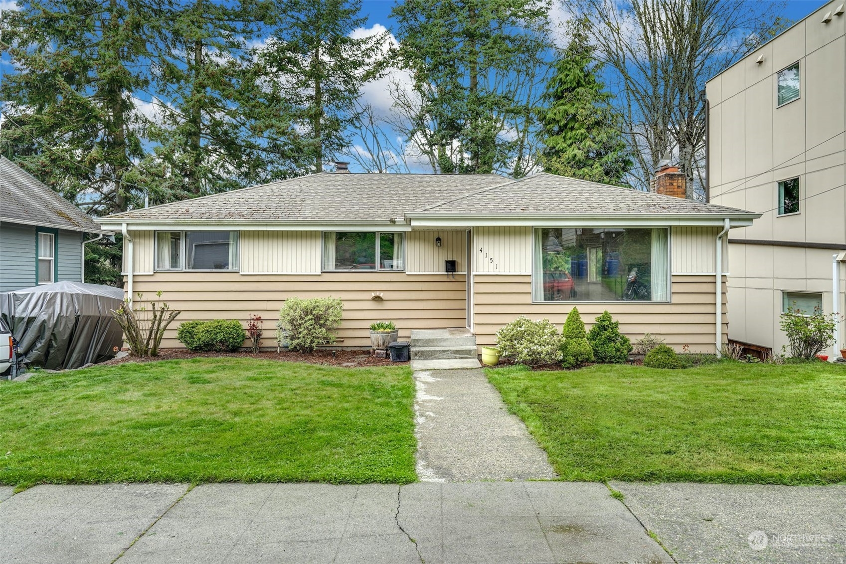 4151 23rd Avenue Southwest Seattle, WA 98106 - Photo 2 of 36 a front view of a house with a yard