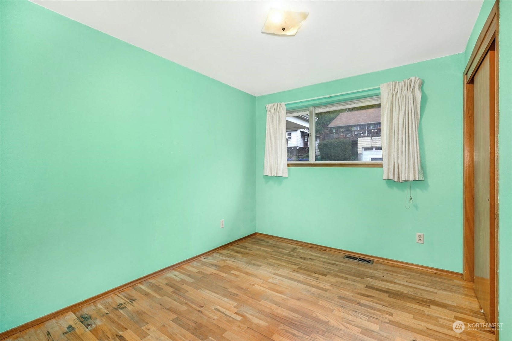 4151 23rd Avenue Southwest Seattle, WA 98106 - Photo 21 of 36 a view of a room with a wooden floor and a window