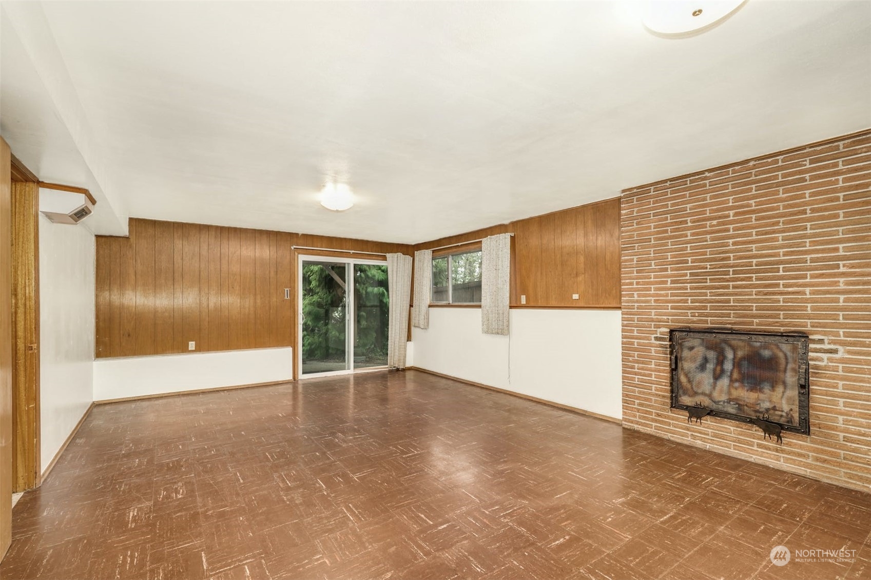 4151 23rd Avenue Southwest Seattle, WA 98106 - Photo 27 of 36 an empty room with windows and fireplace