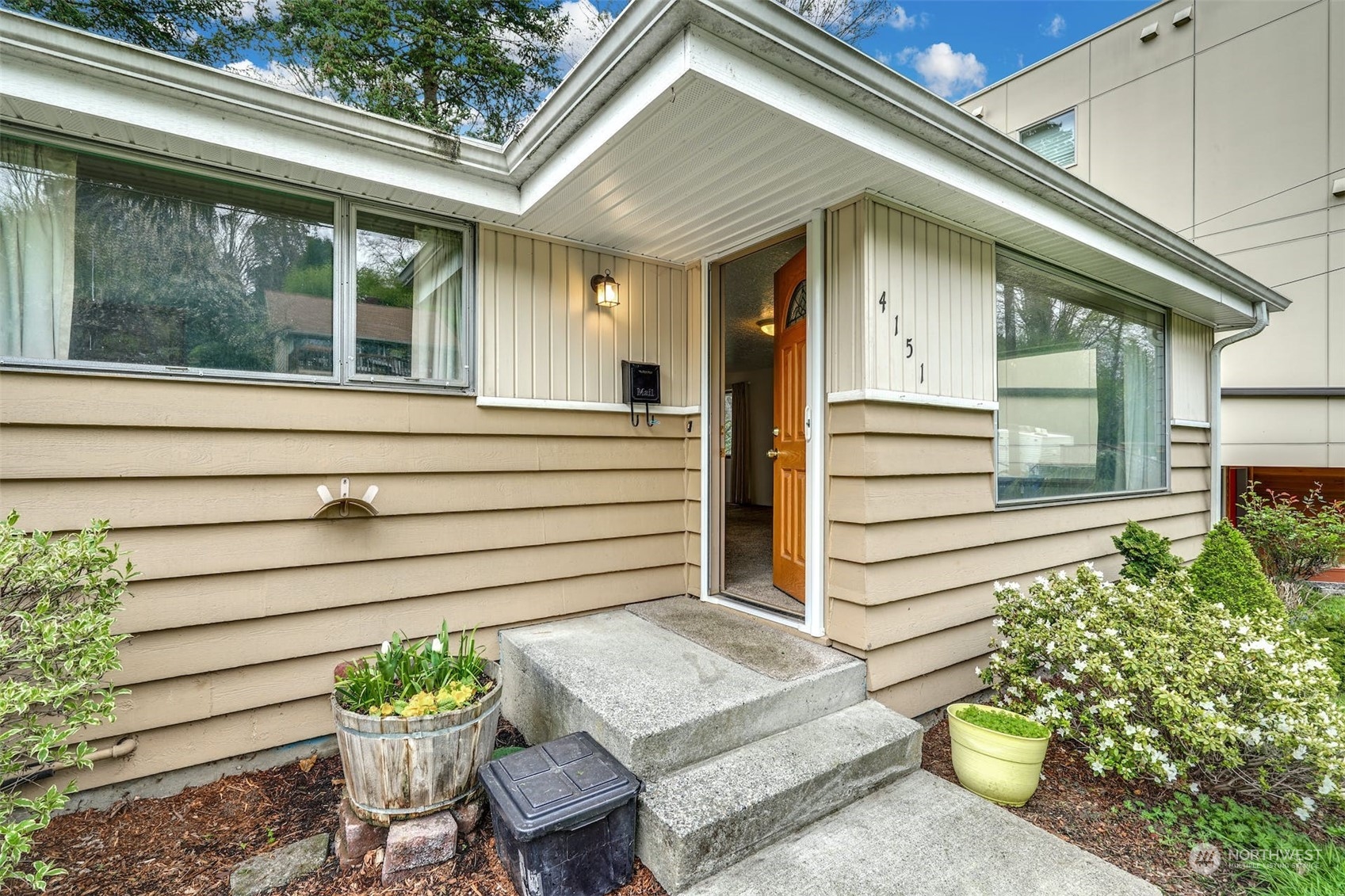 4151 23rd Avenue Southwest Seattle, WA 98106 - Photo 3 of 36 a front view of a house with a chair