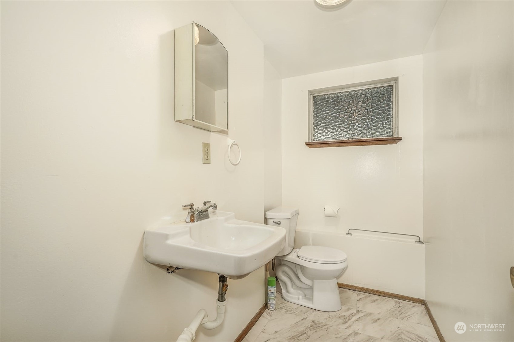 4151 23rd Avenue Southwest Seattle, WA 98106 - Photo 32 of 36 a bathroom with a toilet a sink and mirror