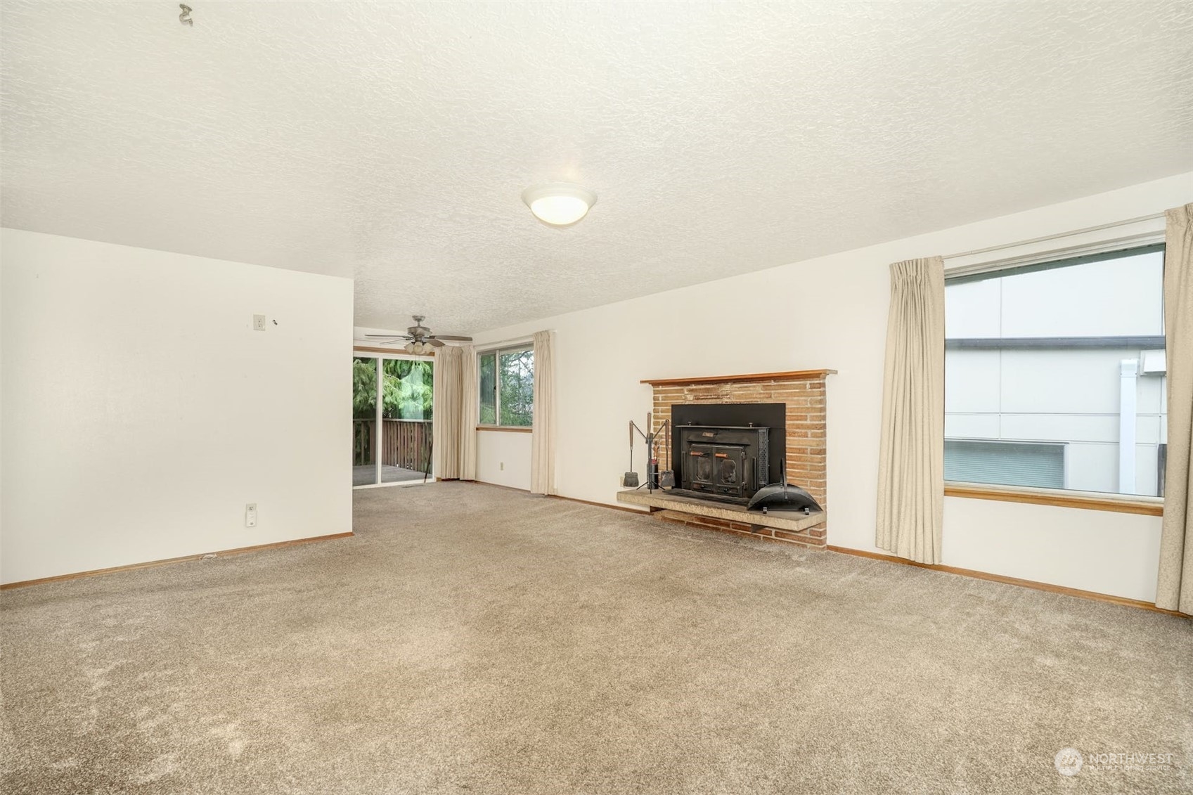 4151 23rd Avenue Southwest Seattle, WA 98106 - Photo 9 of 36 an empty room with windows and fireplace