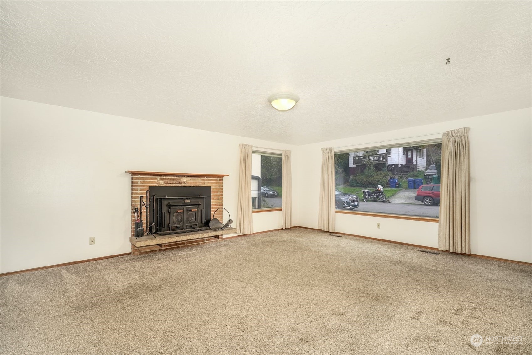 4151 23rd Avenue Southwest Seattle, WA 98106 - Photo 10 of 36 a view of an empty room with a fireplace and a window