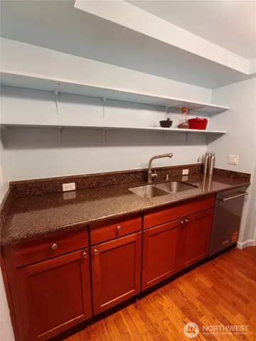 a kitchen with granite countertop cabinets and white countertops with wooden floor