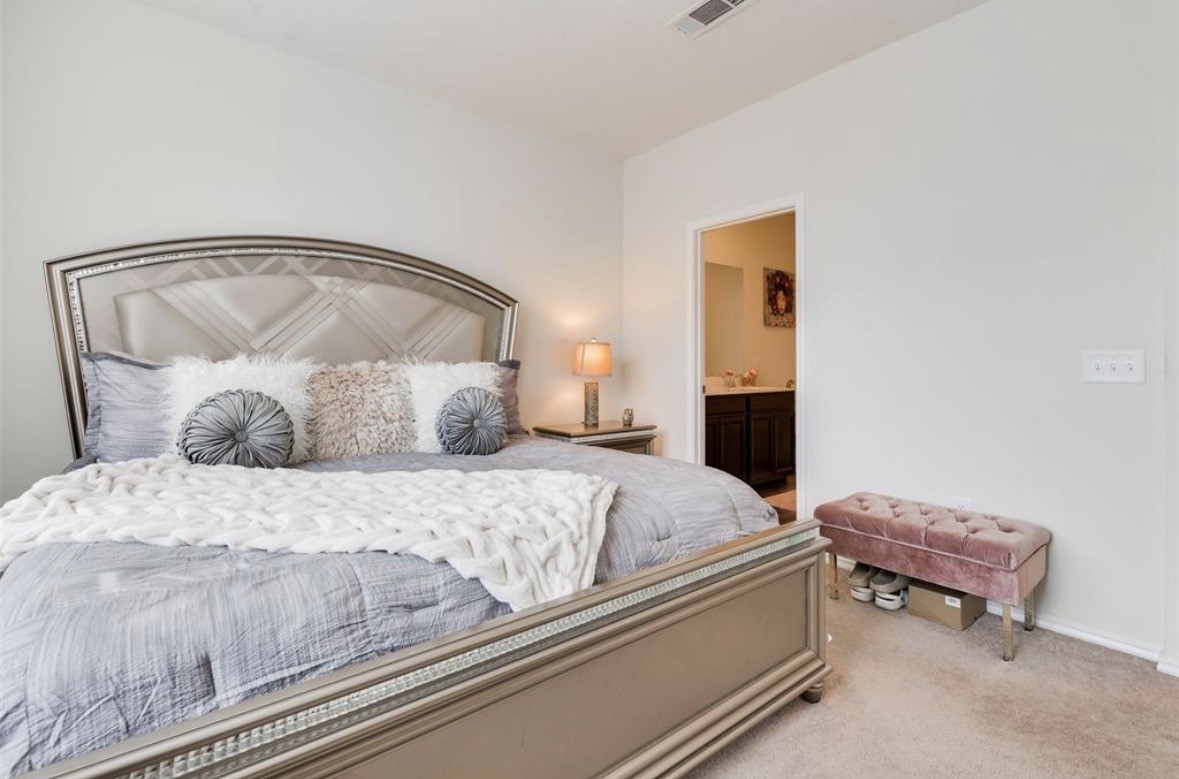 25535 Pitchfork Ranch Place Katy, TX 77493 - Photo 14 of 25 a bedroom with a bed and a mirror