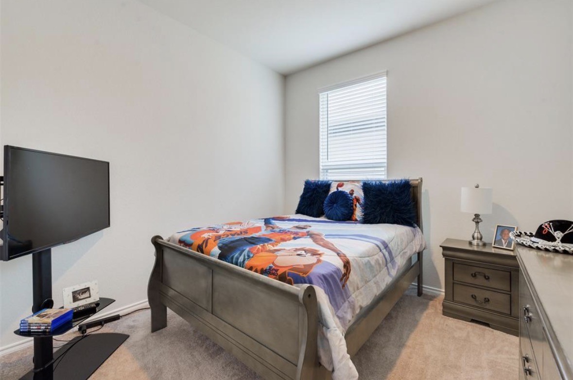 25535 Pitchfork Ranch Place Katy, TX 77493 - Photo 17 of 25 a bedroom with a bed and a flat screen tv