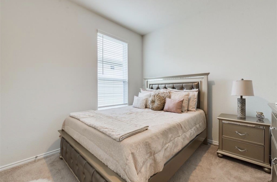 25535 Pitchfork Ranch Place Katy, TX 77493 - Photo 19 of 25 a bedroom with a bed and a window