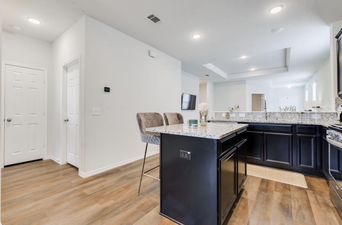 25535 Pitchfork Ranch Place Katy, TX 77493 - Photo 24 of 25 a kitchen with a sink cabinets and wooden floor