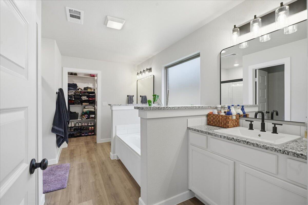 7416 30th Street Lubbock, TX 79407 - Photo 17 of 31 a bathroom with double vanity and a mirror