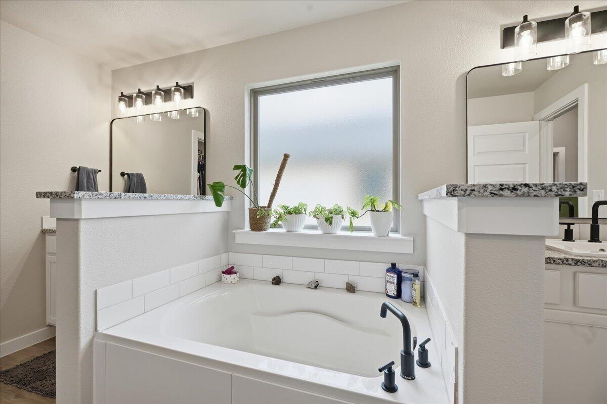 7416 30th Street Lubbock, TX 79407 - Photo 18 of 31 a bathroom with a bathtub and a sink
