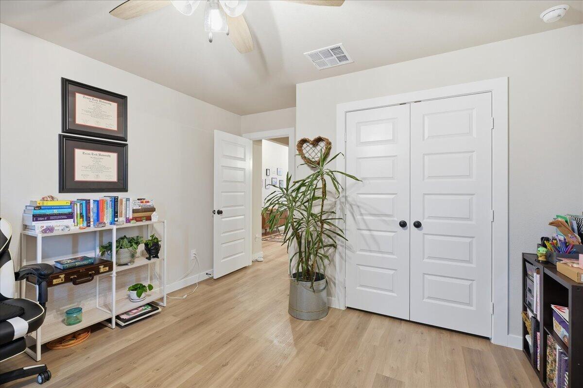 7416 30th Street Lubbock, TX 79407 - Photo 25 of 31 a room with furniture and wooden floor