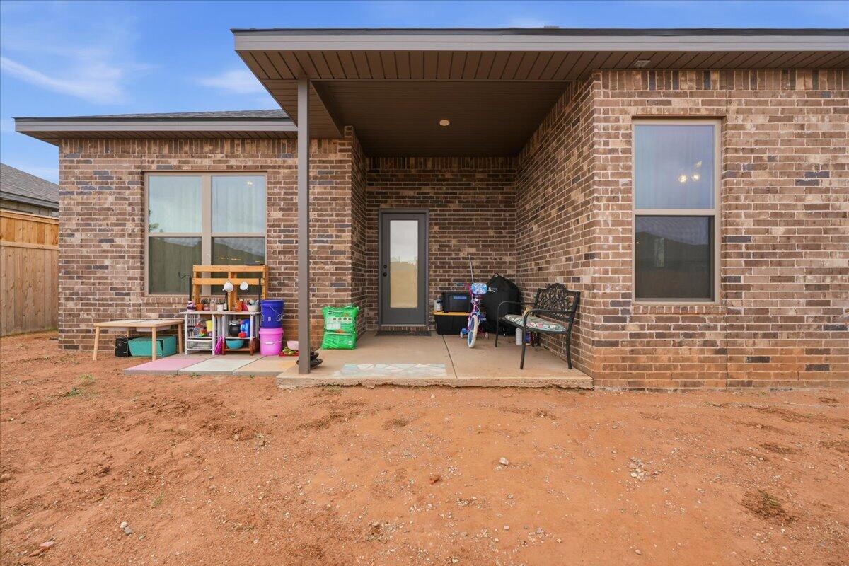 7416 30th Street Lubbock, TX 79407 - Photo 31 of 31 a view of a brick house with chairs and a garage